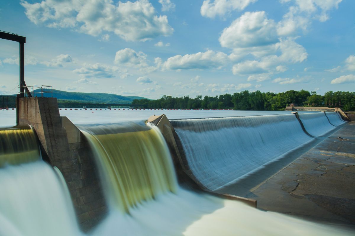 A dam with water flowing over it. 