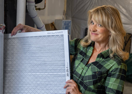 PowerHouse's Megan holding a furnace filter