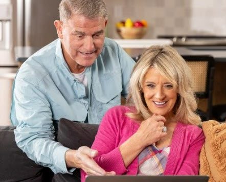 Pete and Megan looking at a laptop