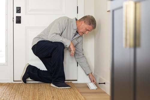 a man replacing a vent cover