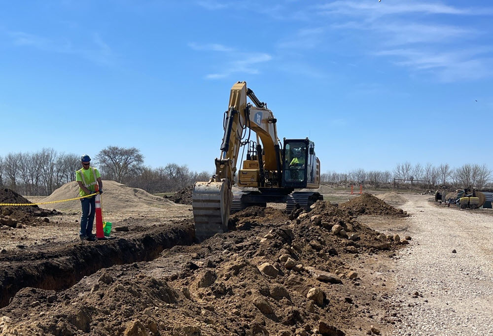 construction vehicle digging a trench