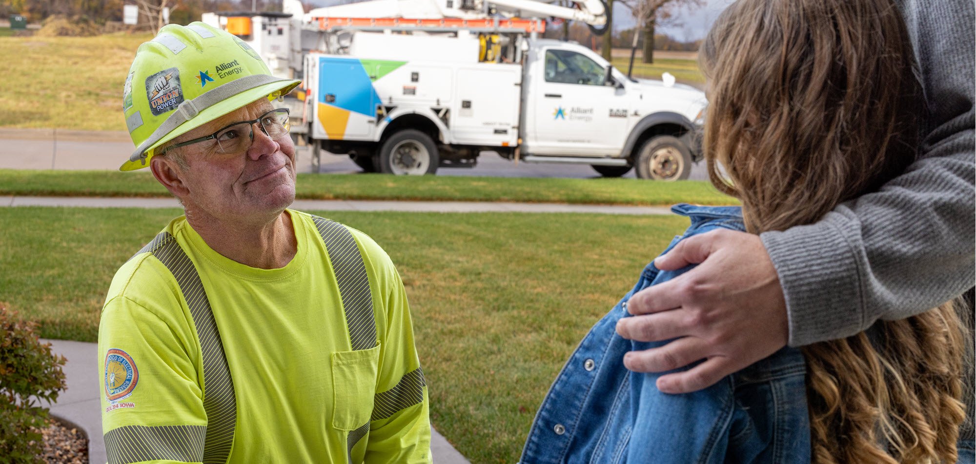 Alliant Energy employee talking to a family