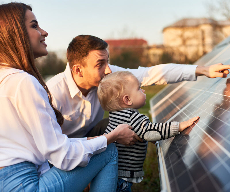 Family looking at solar panels