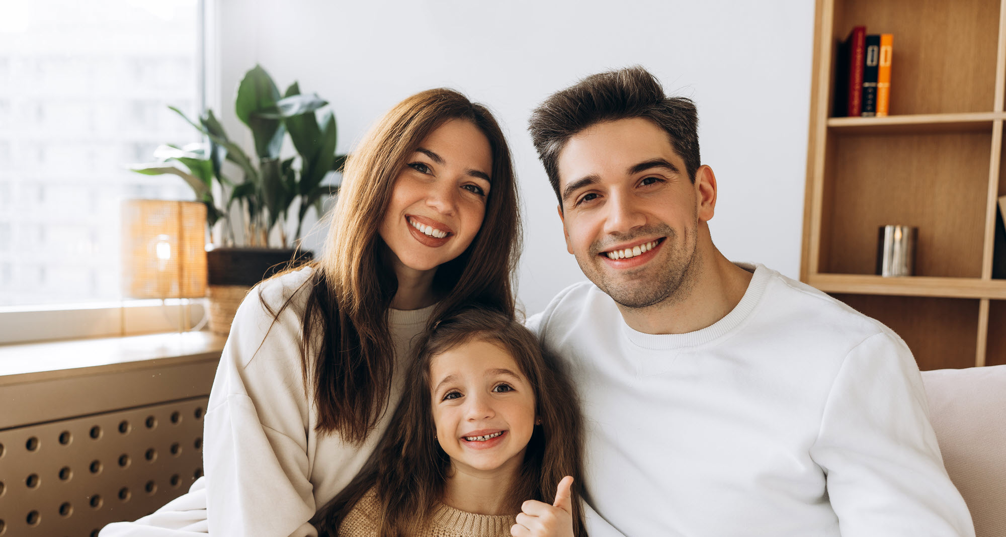 mom, dad, daughter on couch