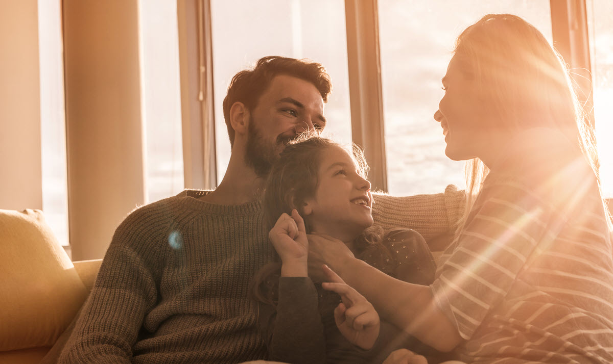 family next to a sunny window