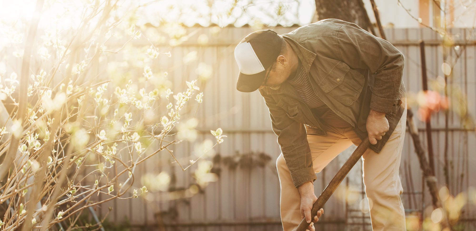 man digging in yard