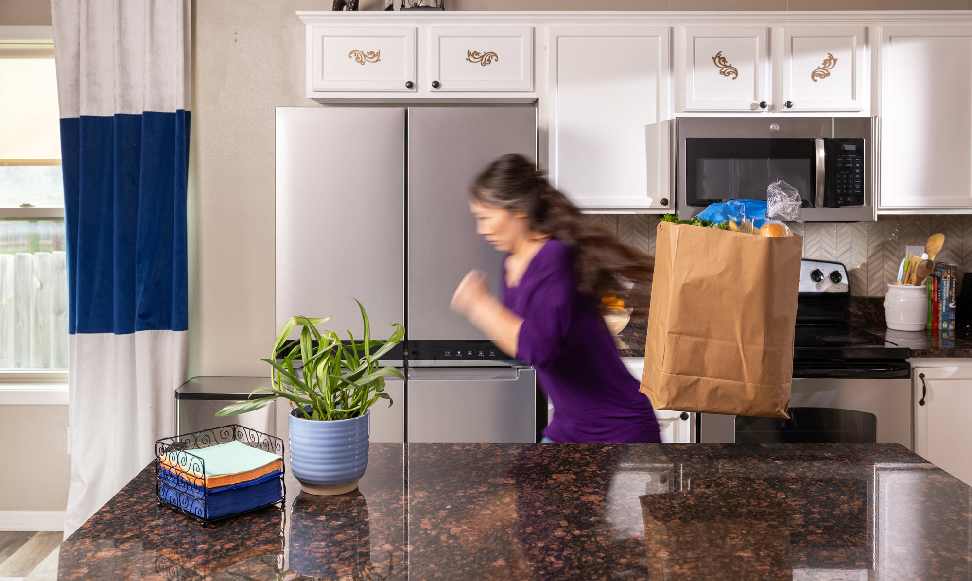 woman in kitchen running away