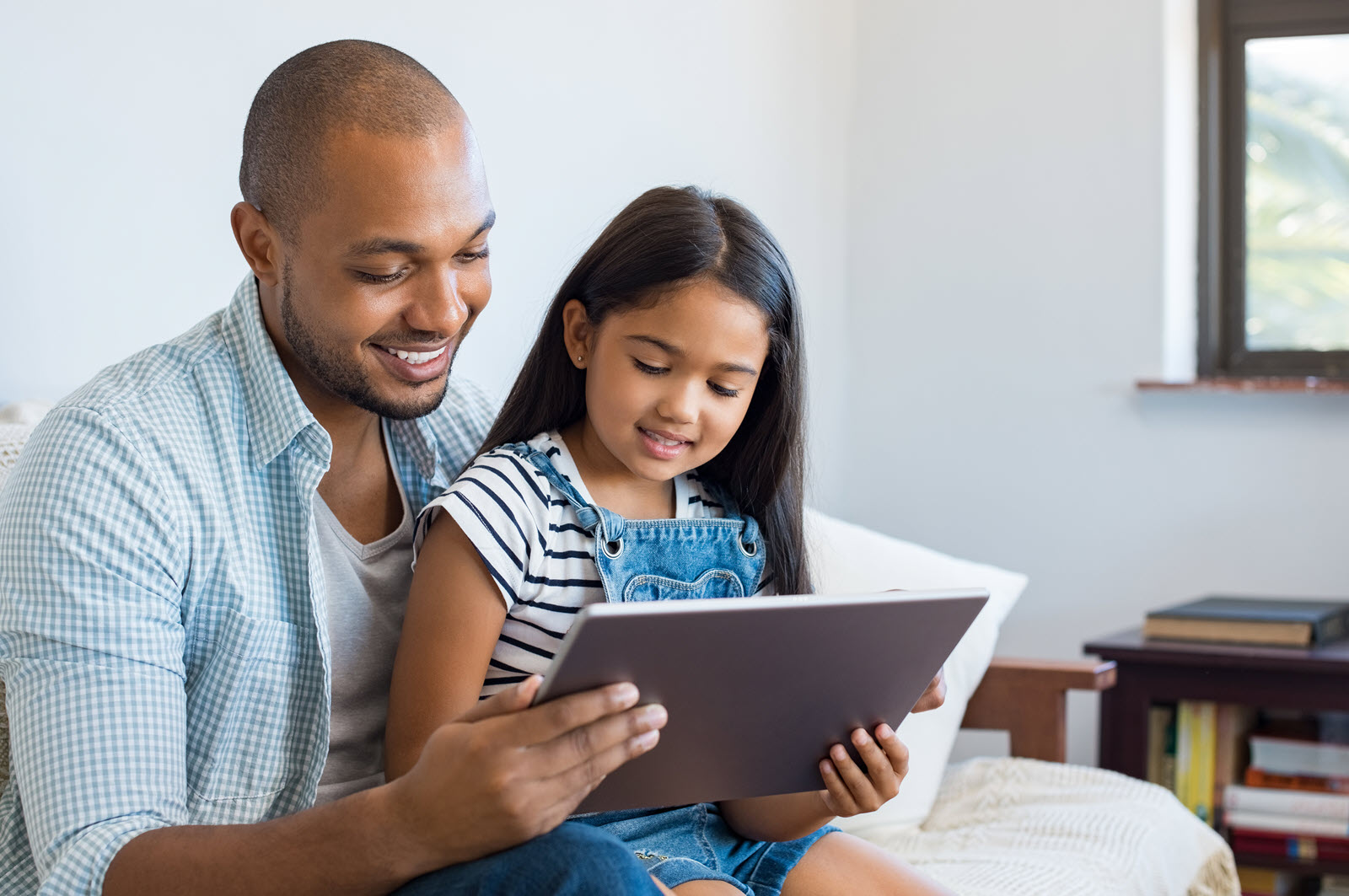 Dad and daughter on a tablet
