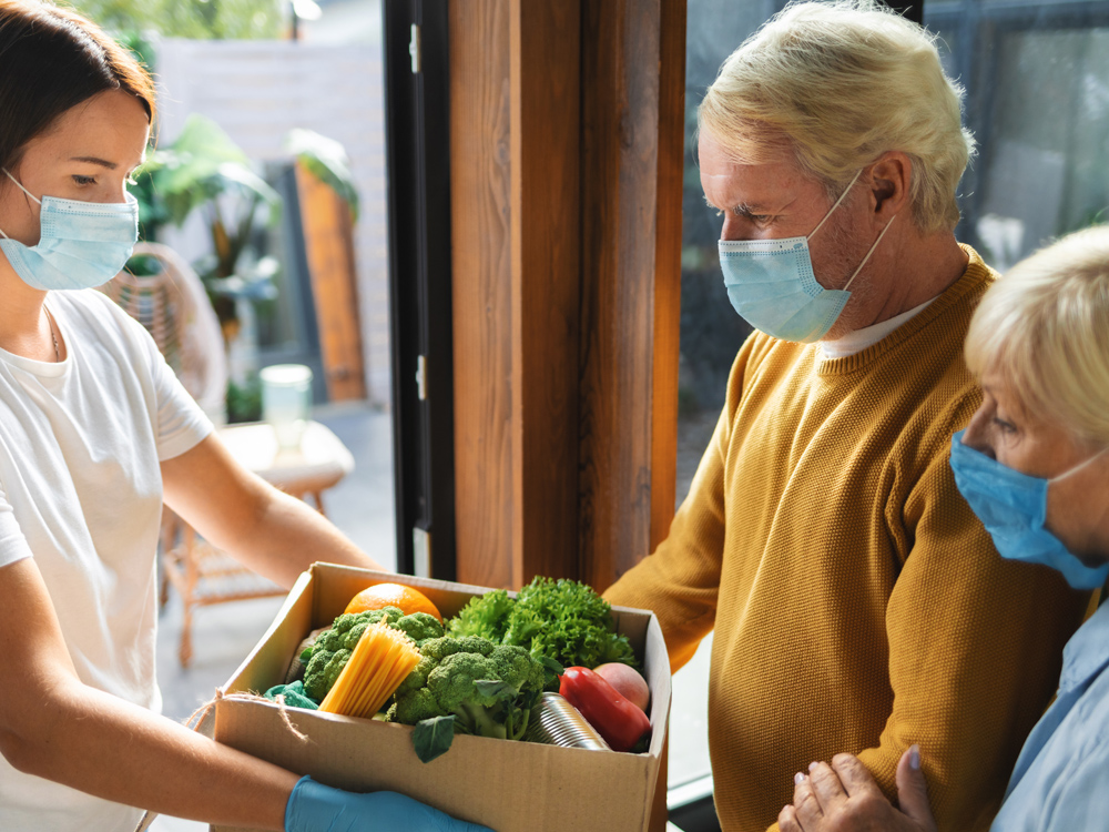 Couple receiving a box of vegetables
