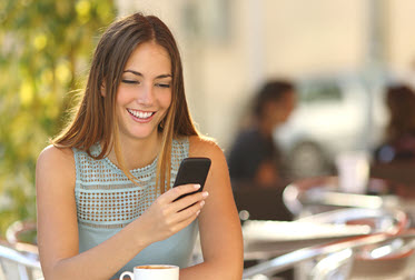 a woman outside on her cell phone
