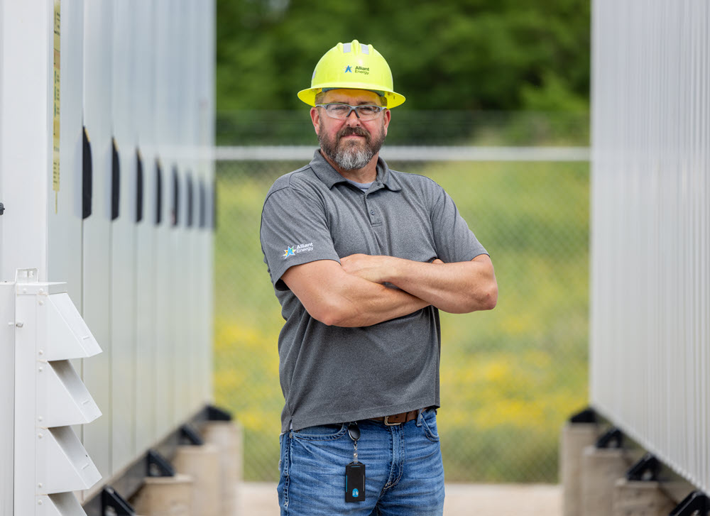 employee standing near energy storage equipment