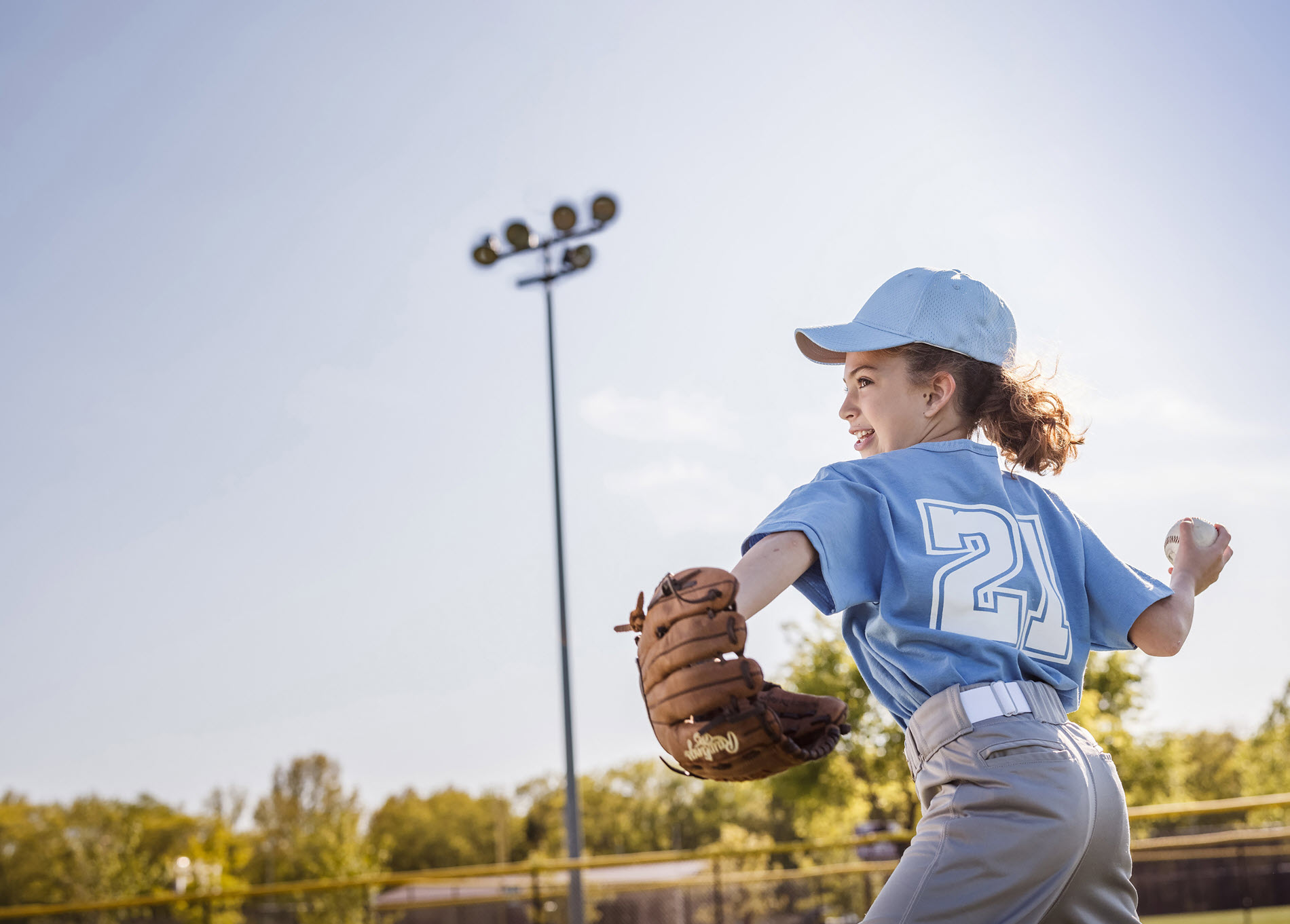 girl throwing a baseball