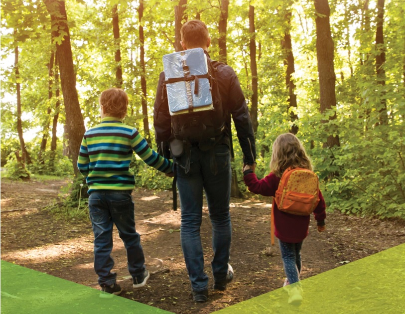 man with kids walking in woods