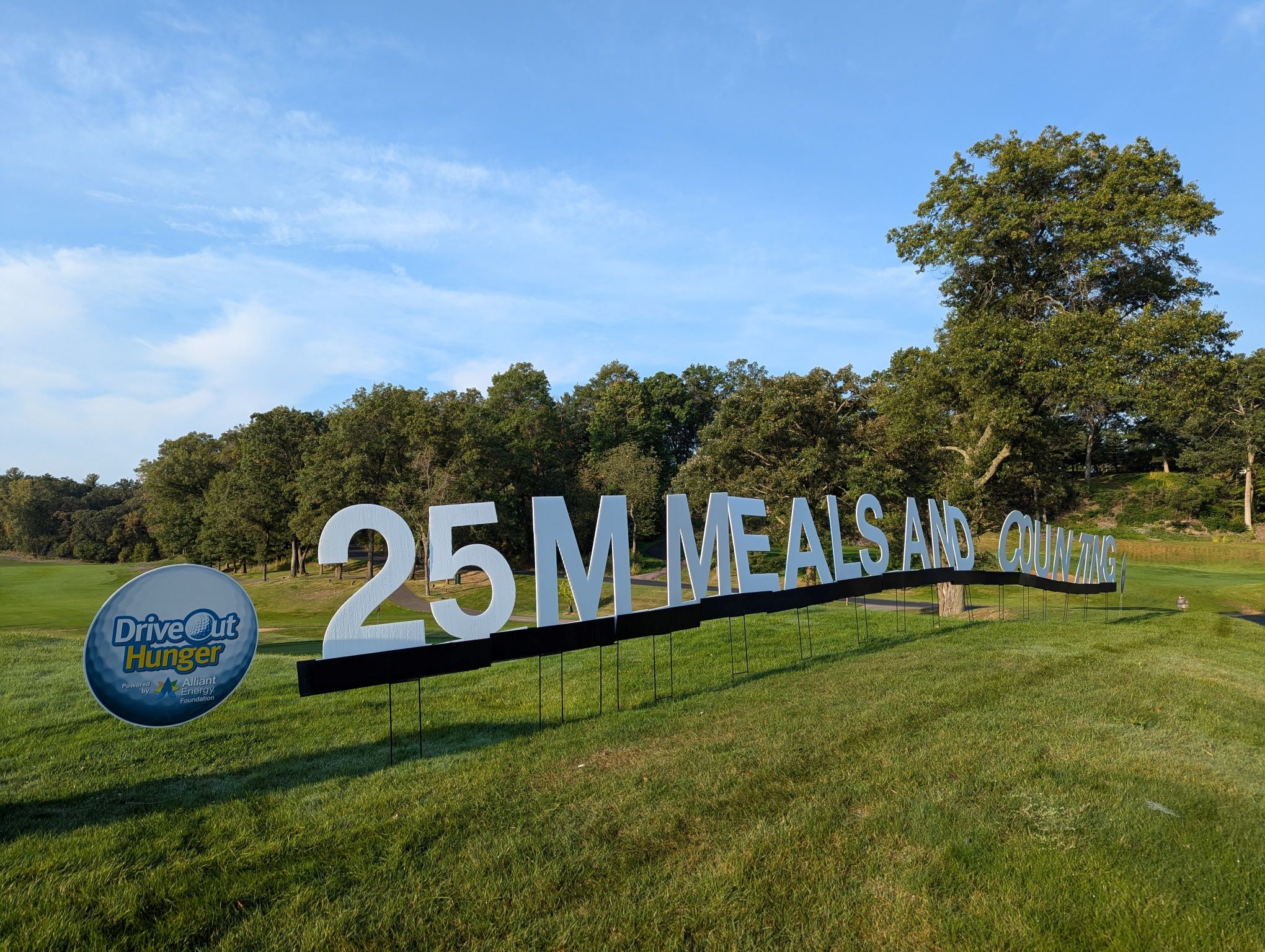 Drive Out Hunger sign on hill