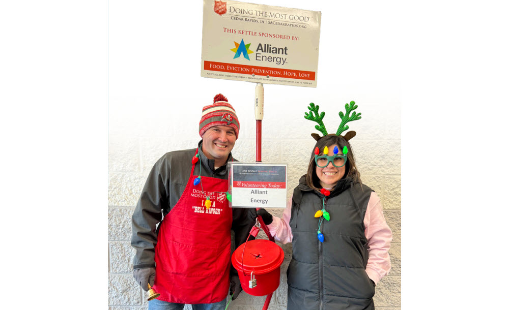 Two employee volunteers ringing bells
