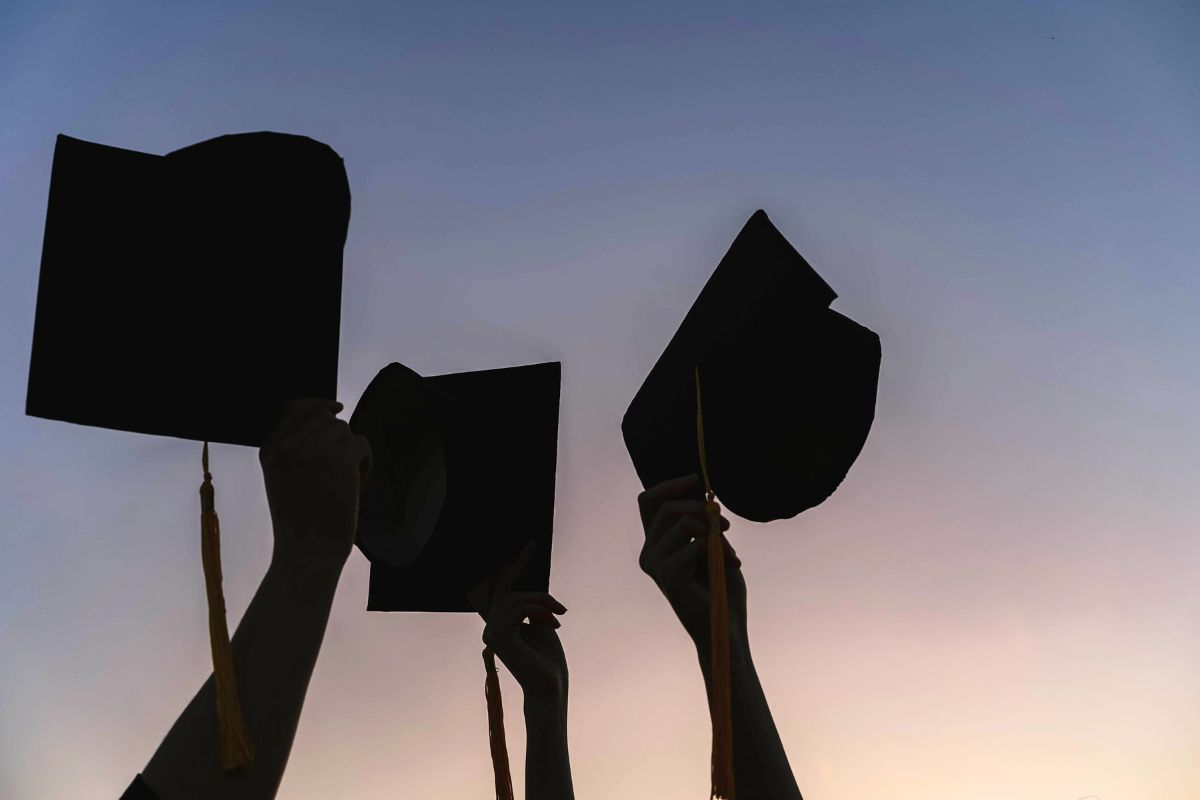 silhouette of graduation caps