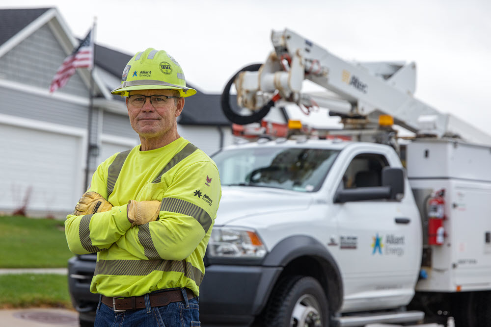 Alliant Energy employee standing in front of a truck
