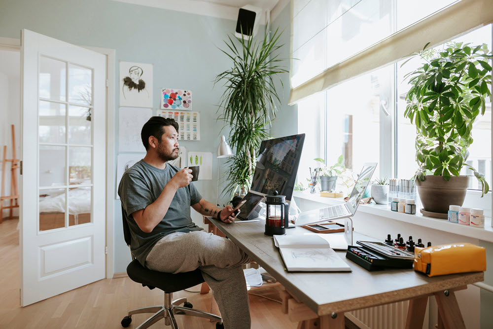 man sitting at a desk with a computer