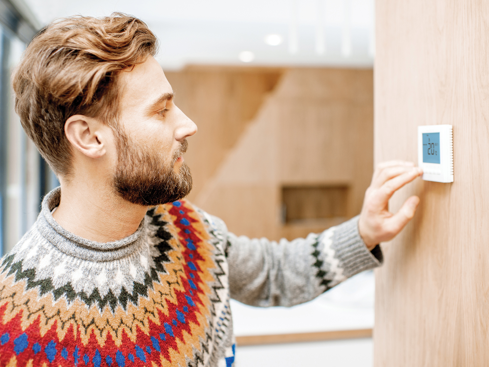 Man at thermostat