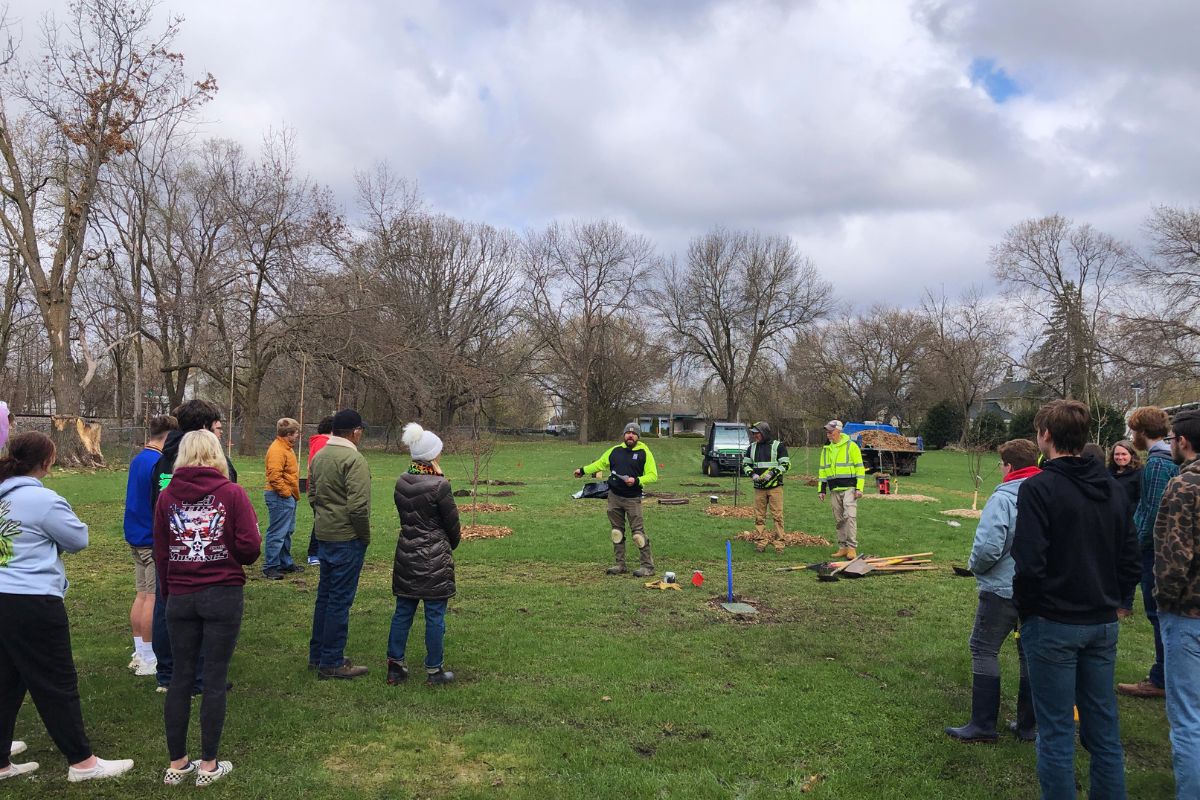 Students participating in a community tree planting in Mauston
