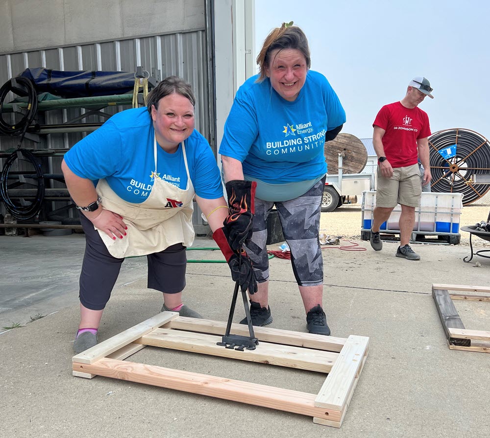 two employees building a bed frame