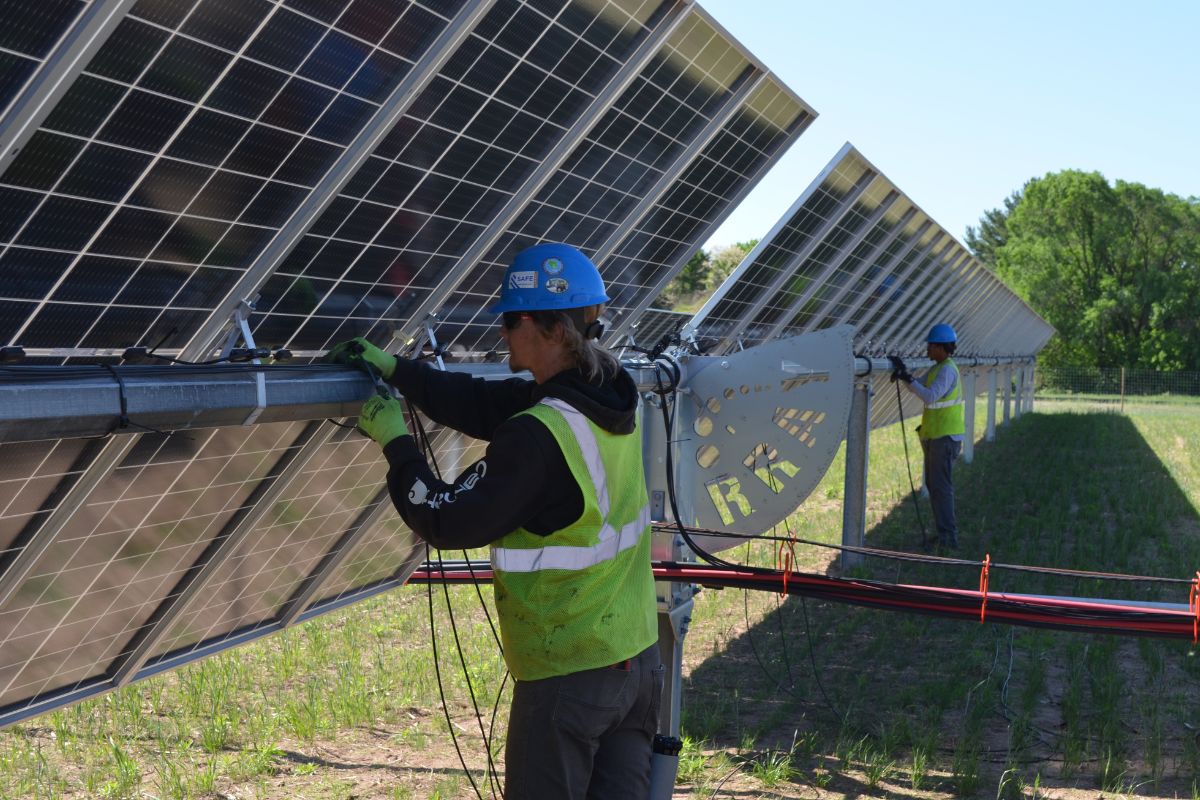 Worker installing a solar panel. 