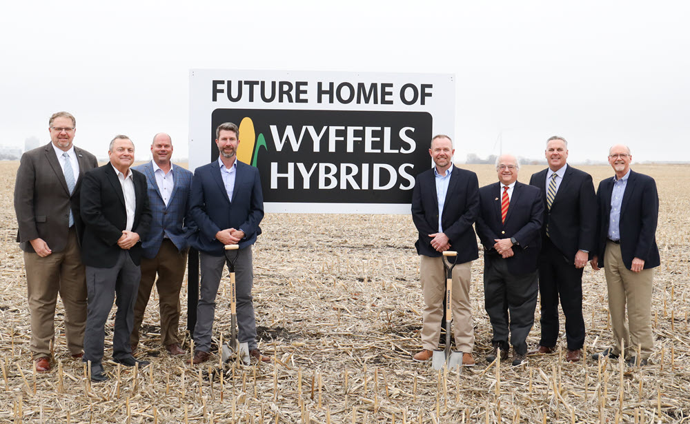 group of people at a groundbreaking in a field