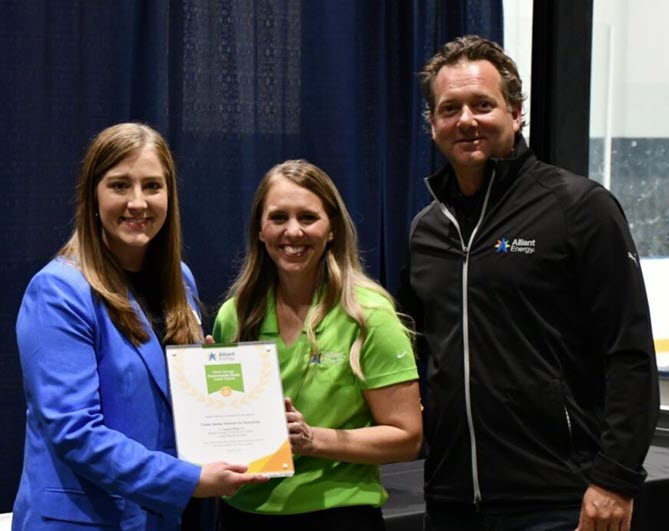 Brittany Scanlon (Cedar Valley Habitat for Humanity) with Emily Kaiser and Ben Lapari (Alliant Energy)