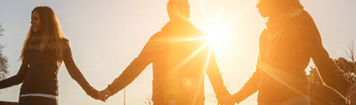 people holding hands in the sun
