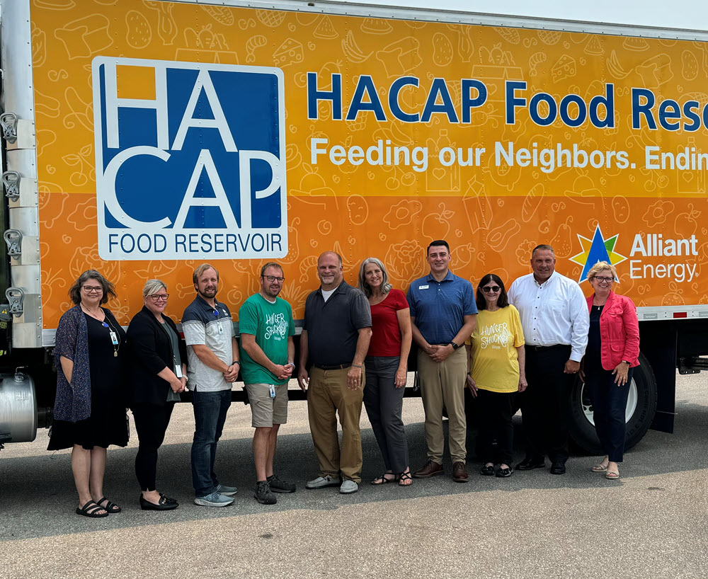 people standing in front of a food bank truck
