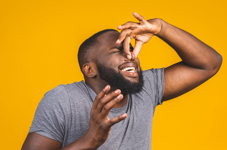 man pinching nose