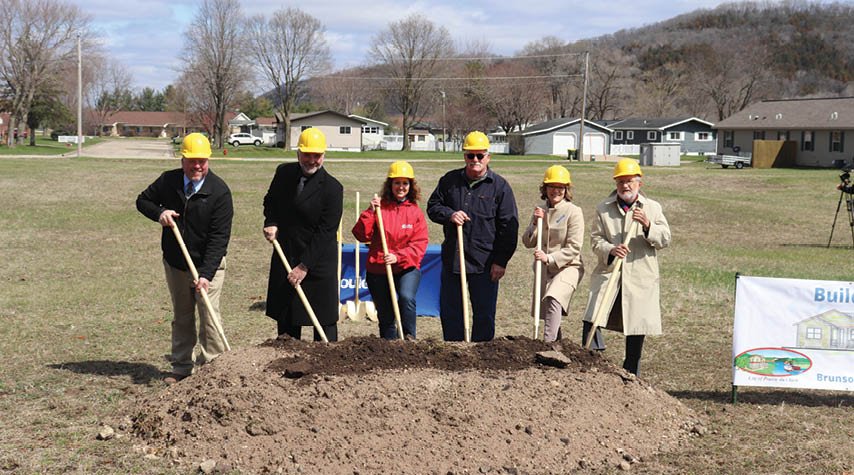 Couleecap and Coulee region of Wisconsin partnership featuring people shoveling dirt together.