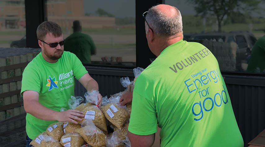 Two volunteers sorting food