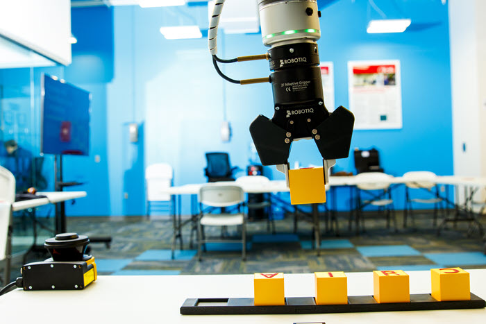 A robot in a laboratory picking up an item