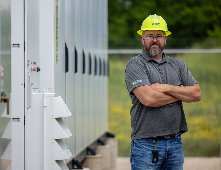 Alliant Energy employee near a storage battery
