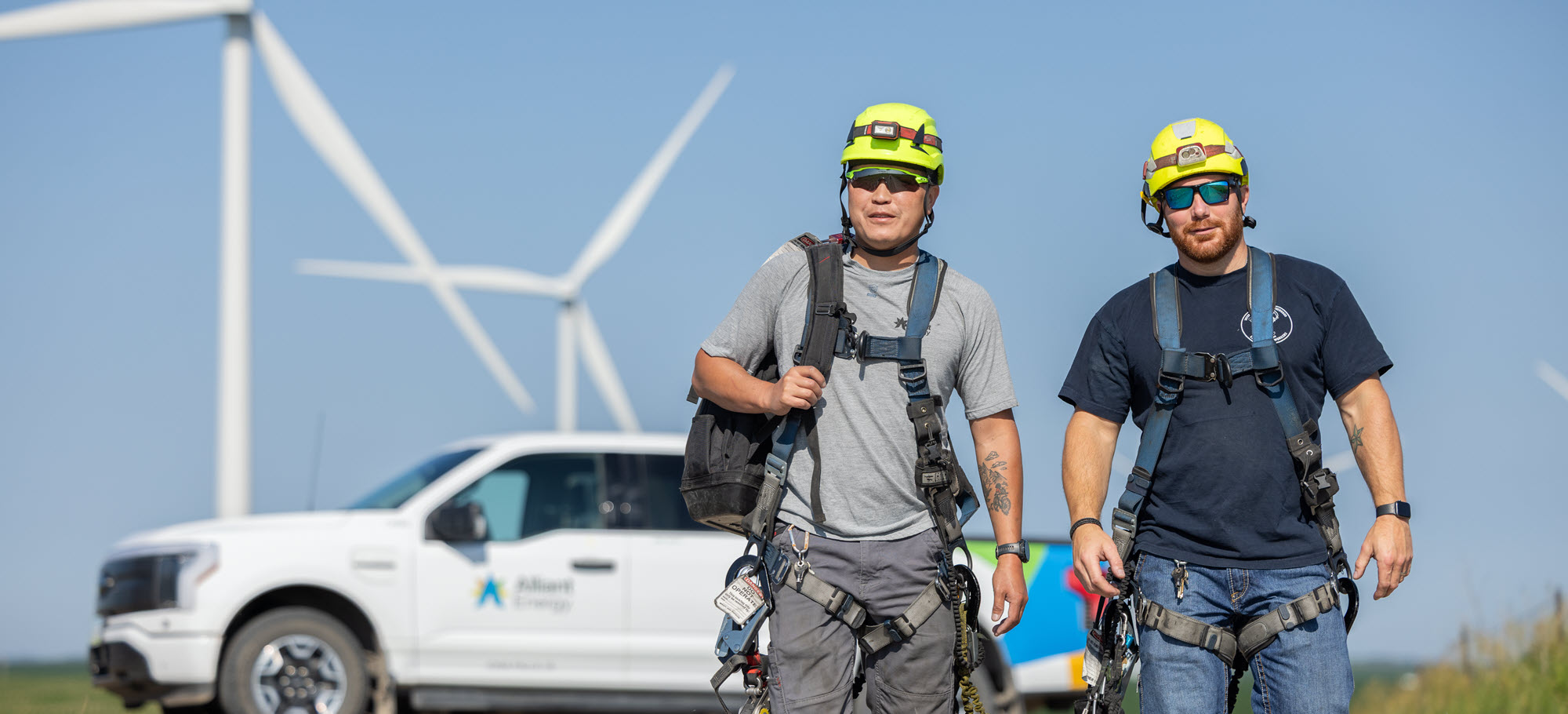 Alliant Energy employees walking in a wind farm