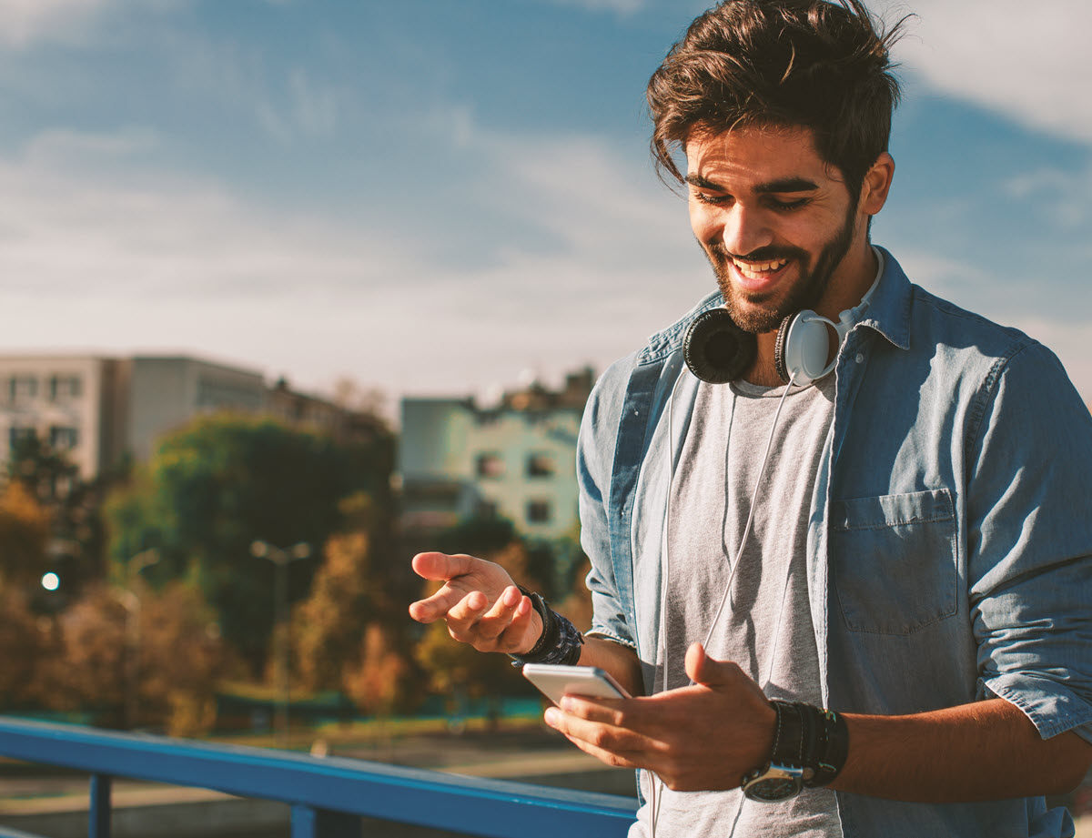 happy man outside with phone