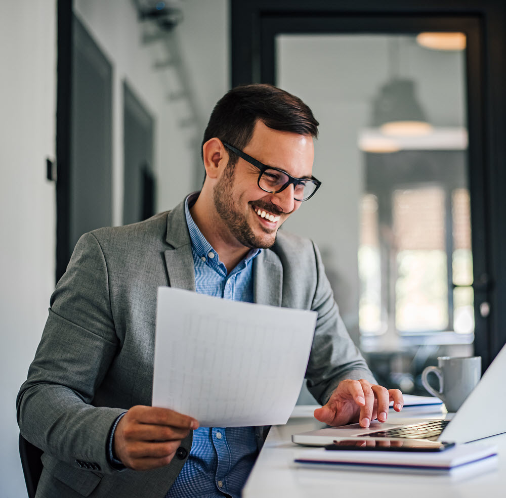 businessman smiling at desk