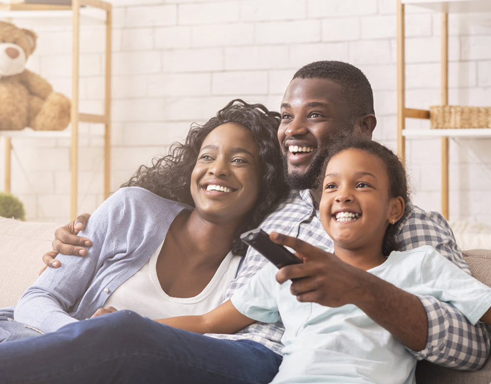 family on a couch watching TV