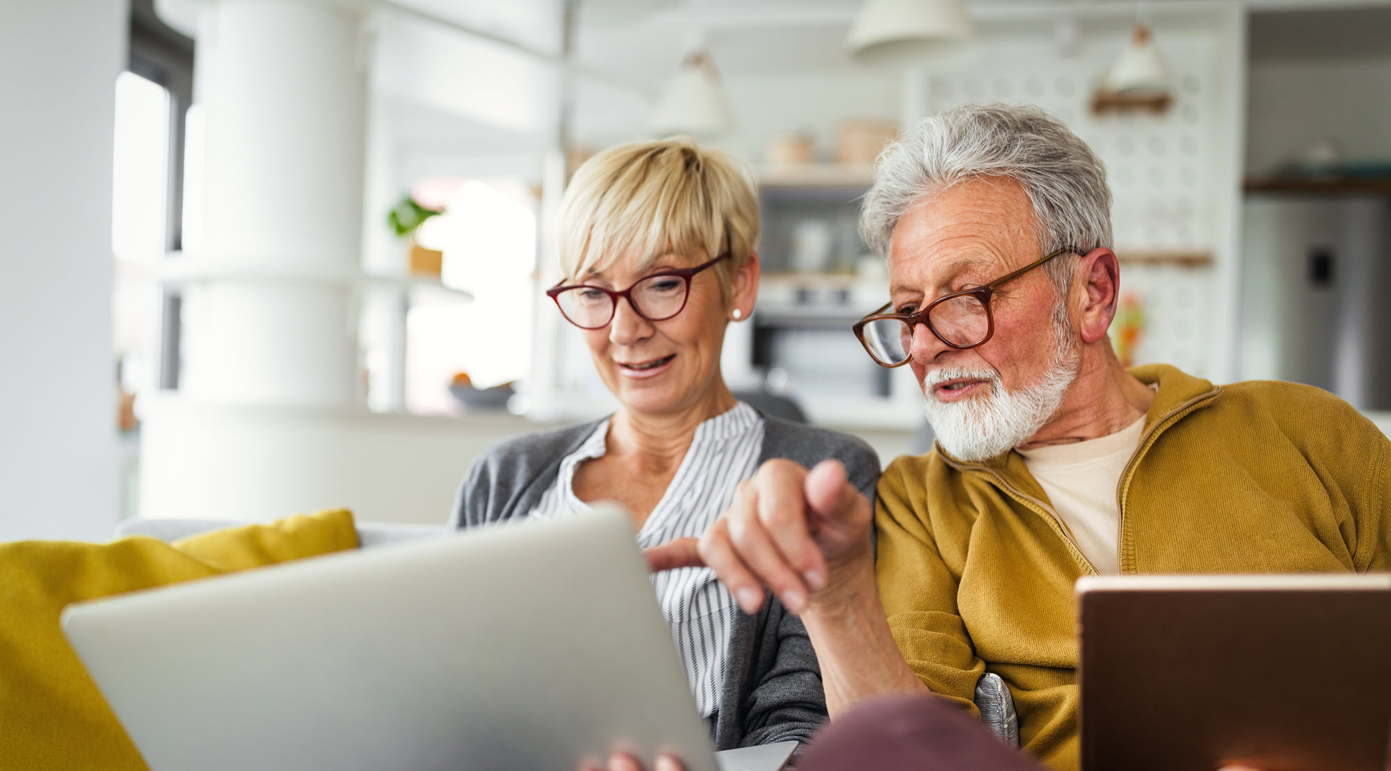 senior couple looking at a laptop