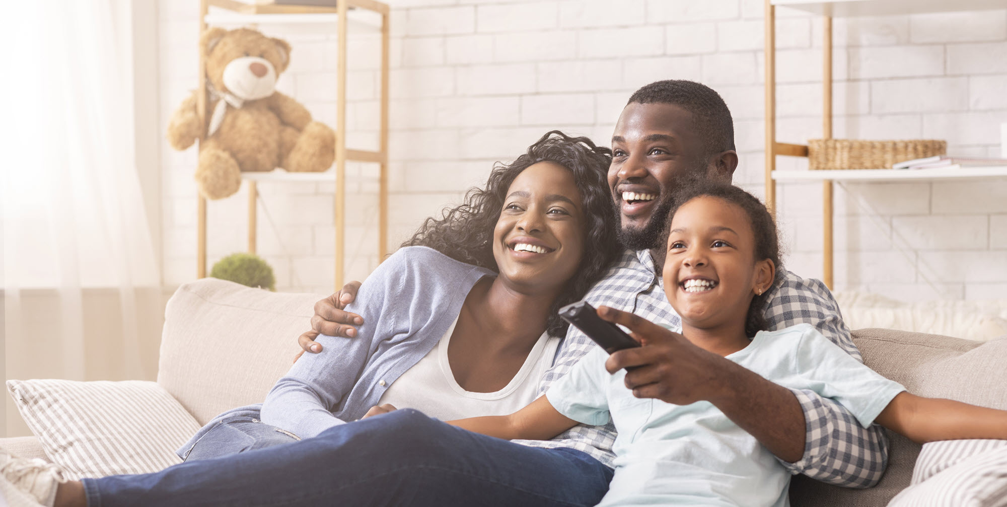 family on a couch watching TV