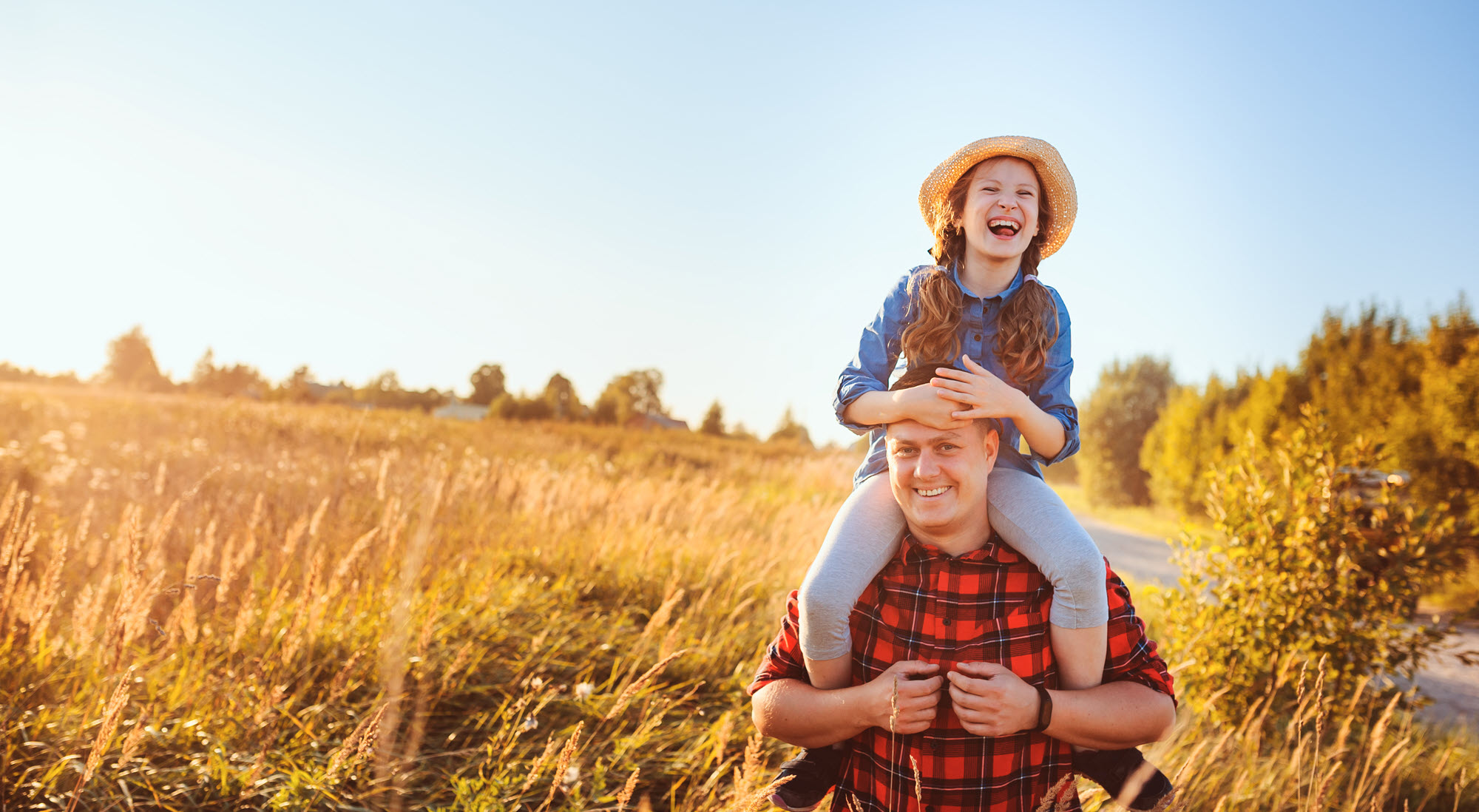 father and daughter in a wheat field