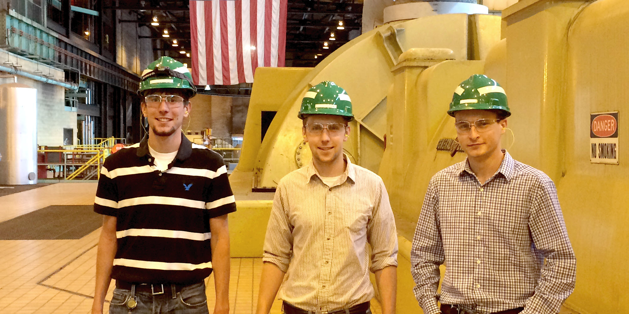 three interns inside a power plant