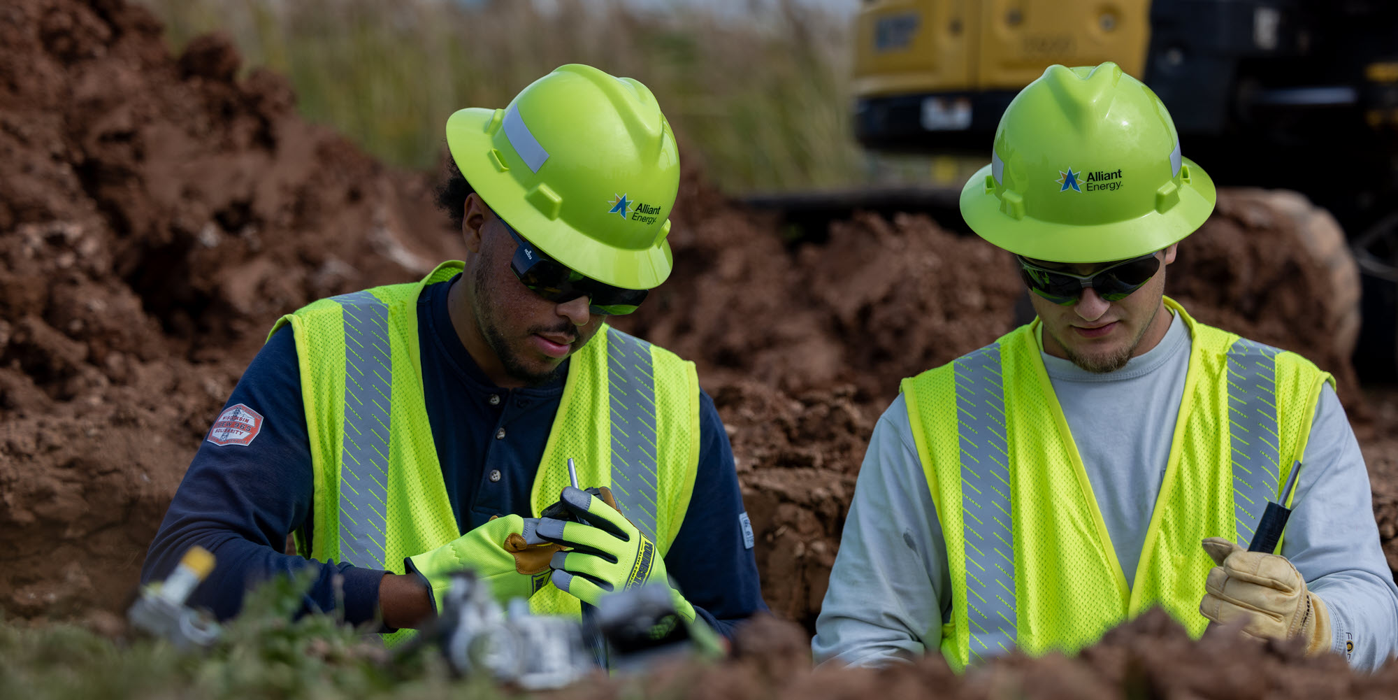 Two Alliant Energy employees on a construction site