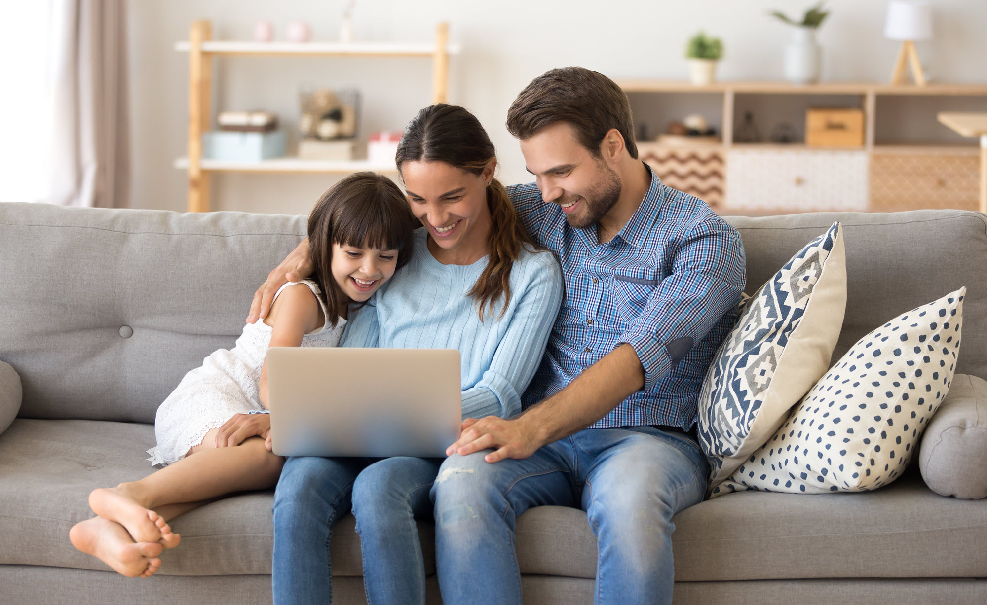 family on couch with a laptop