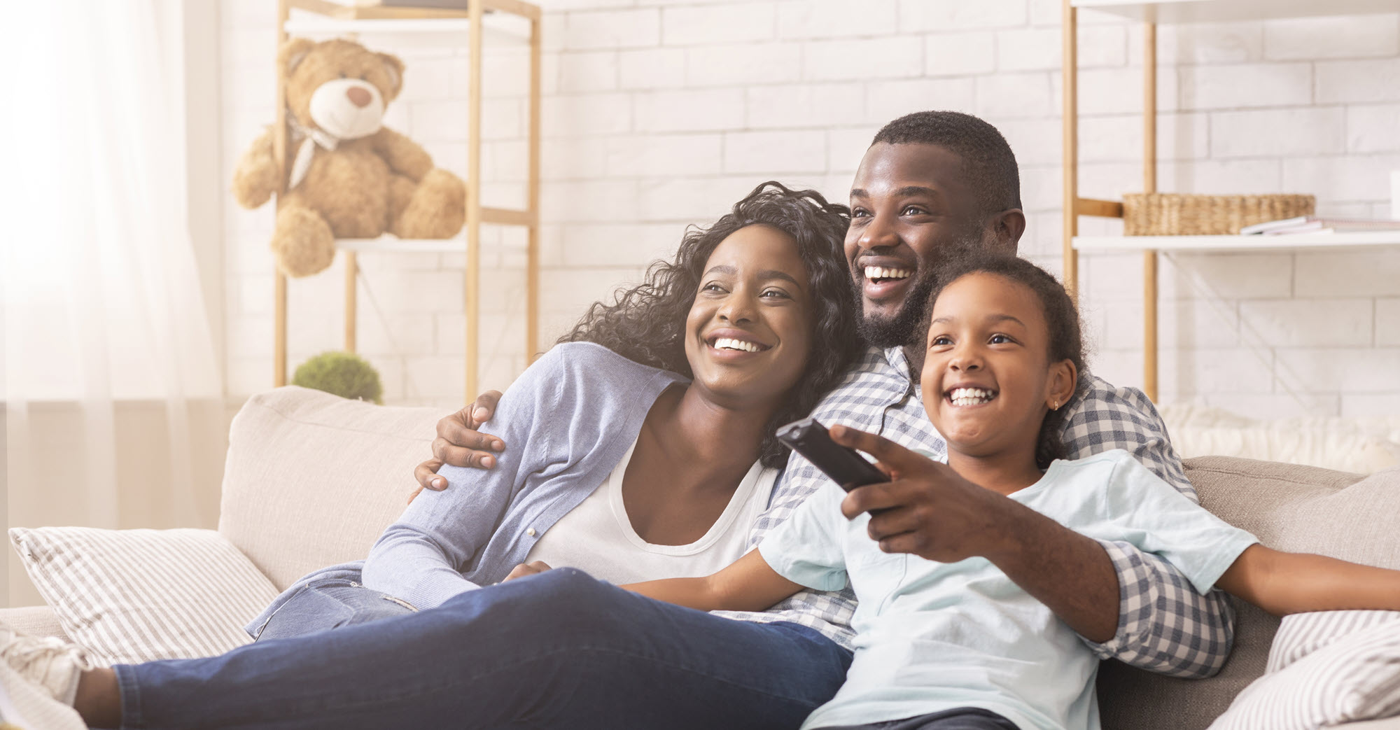 happy family on couch watching TV