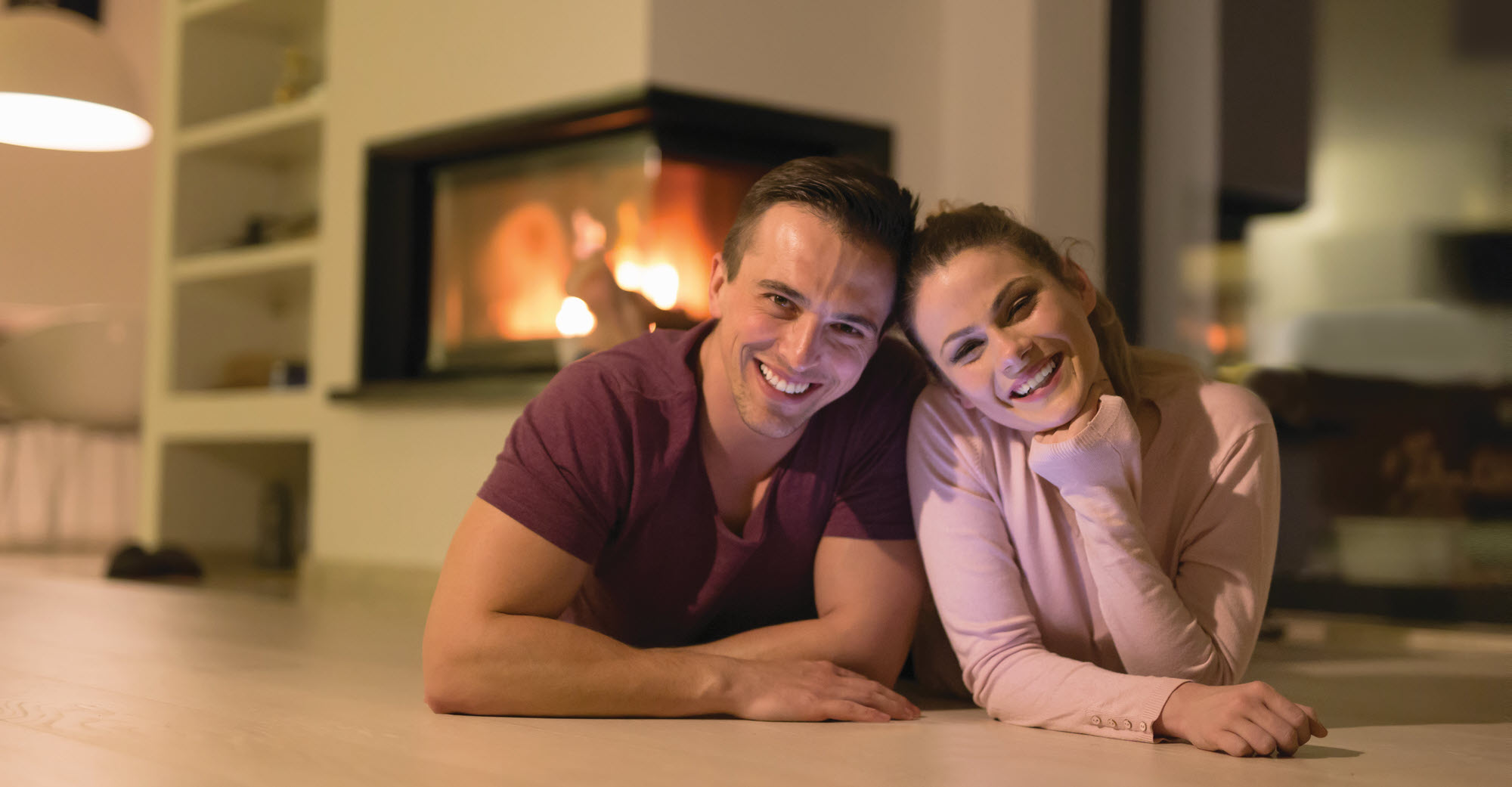 happy young couple near a fireplace