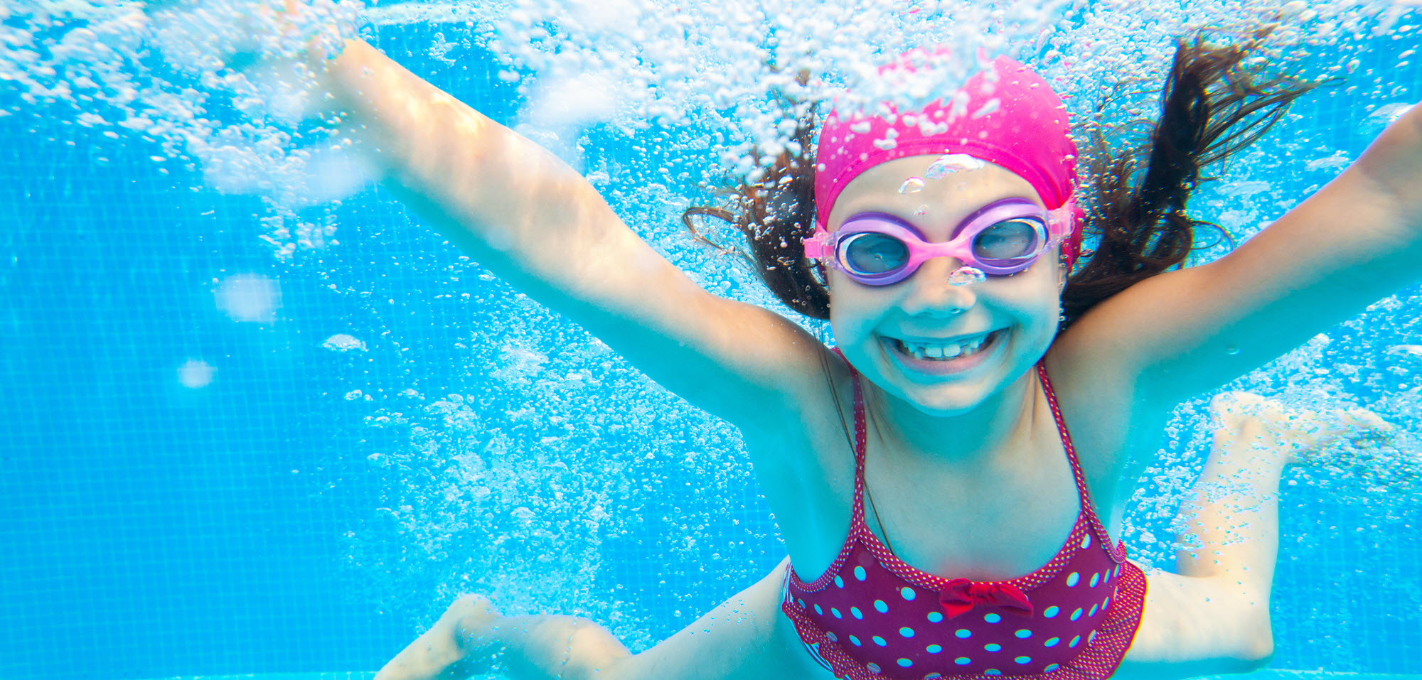 girl smiling in a swimming pool