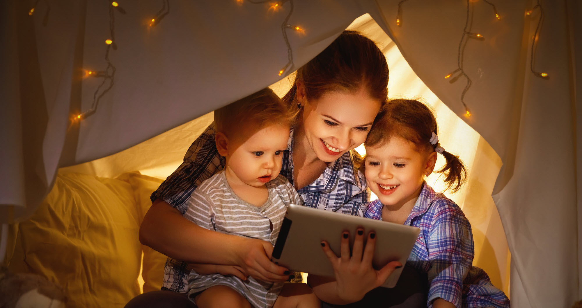 mom and two kids in a tent