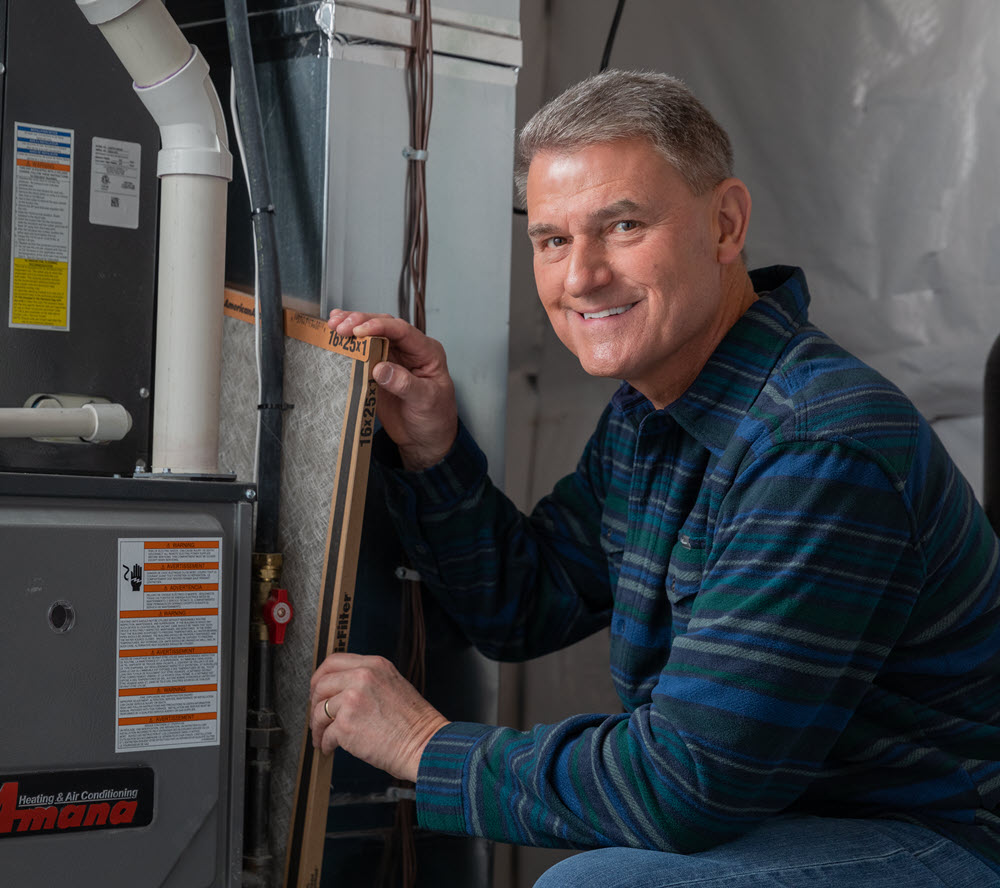 Pete from PowerHouse changing a furnace filter